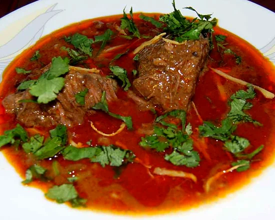 Nihari: beef in a rich red gravy garnished with coriander and ginger