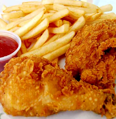Crispy fried chicken pieces with fries and ketchup