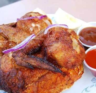 Golden fried chicken with red onion, lemon and two dipping sauces