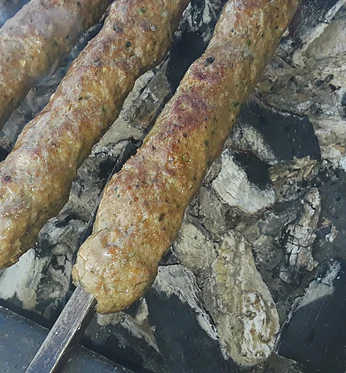 Seekh kababs on skewers over hot charcoal