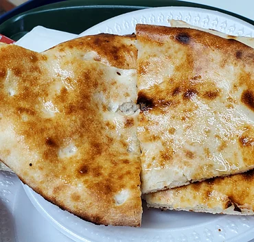 Freshly baked tandoori naan on a plate