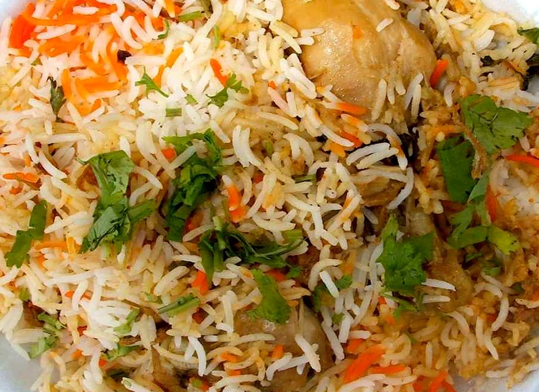Chicken biryani: basmati rice with carrot, coriander and a piece of chicken